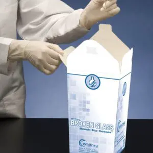 A person in white gloves holding onto a box