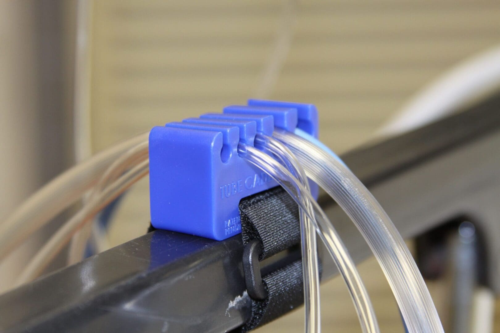 A blue plastic object is attached to some wires.