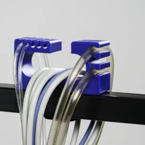 A blue plastic holder with many wires hanging from it.